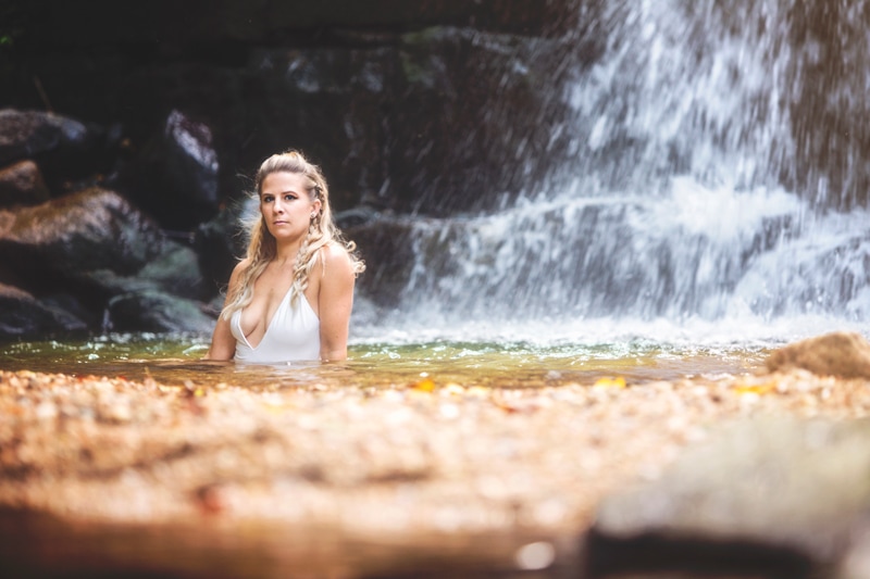 Portrait Photographer, woman standing in the bottom of a waterfall