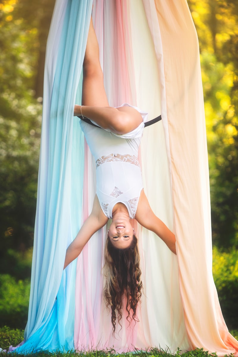 Portrait Photographer, girl swinging upside down on acrobat hoop