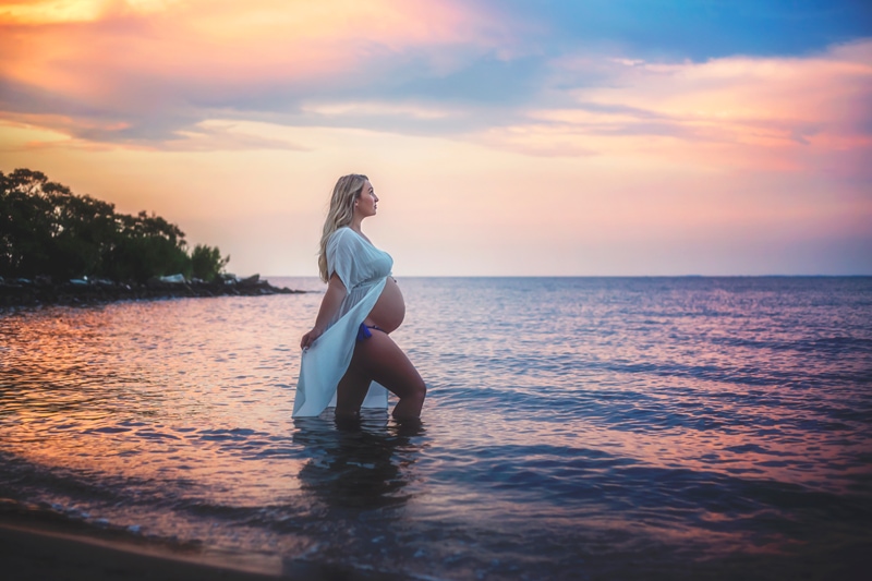 Maternity Photographer, woman standing in the ocean