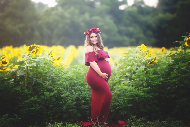 Maternity Photographer, pregnant woman in red dress in field of sunflowers