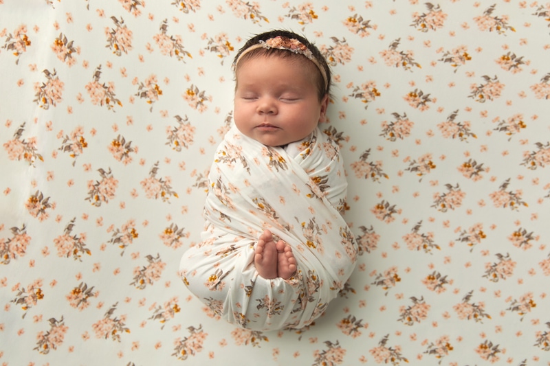Newborn Photography, baby laying on floral blanket