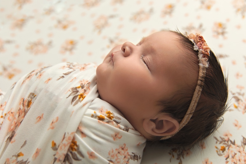 Newborn Photography, baby in peach and cream floral blanket