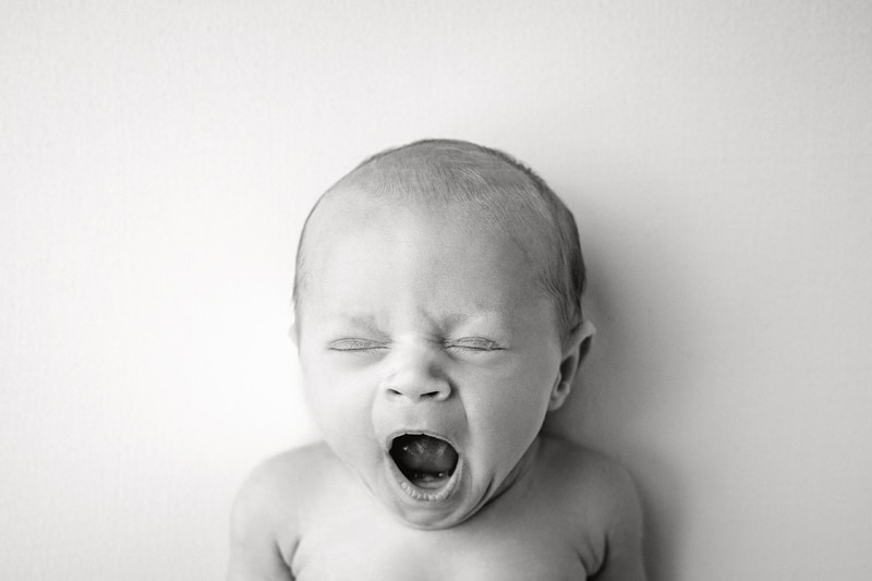 Newborn Photography, black and white image of baby yawning