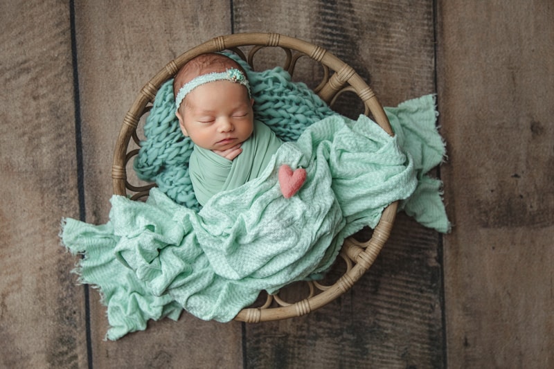 Newborn Photography, baby in teal blanket in basket