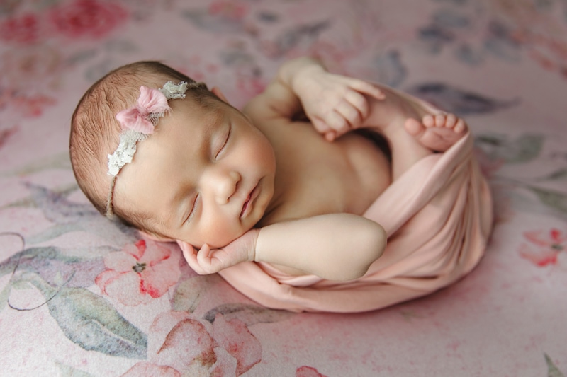 Newborn Photography, baby girl in pink wrap with headband