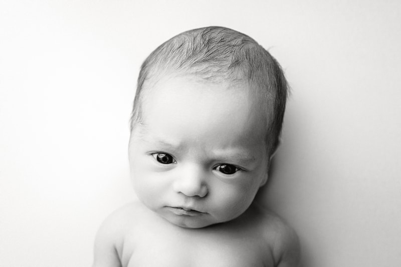 Newborn Photography, black and white image of little baby staring at camera